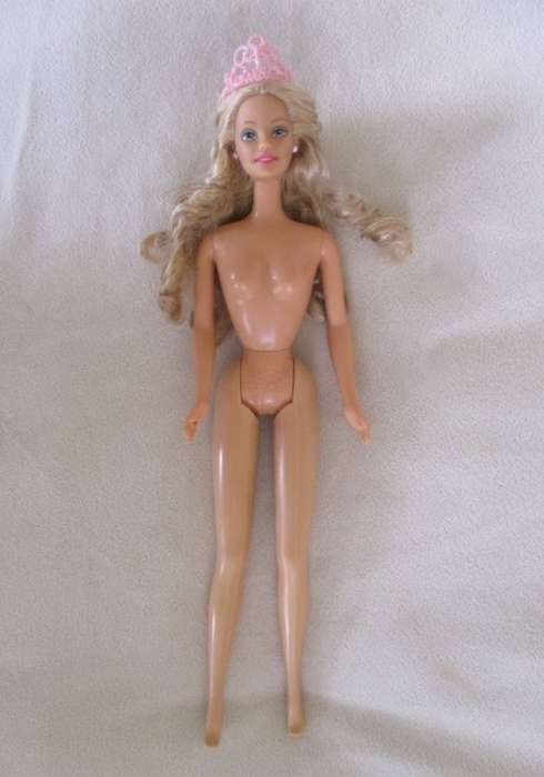 A Mattel Barbie with soft, curly hair with knees that bend - in pretty dress
