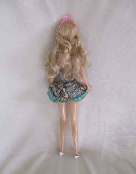 A Mattel Barbie with soft, curly hair with knees that bend - in pretty dress