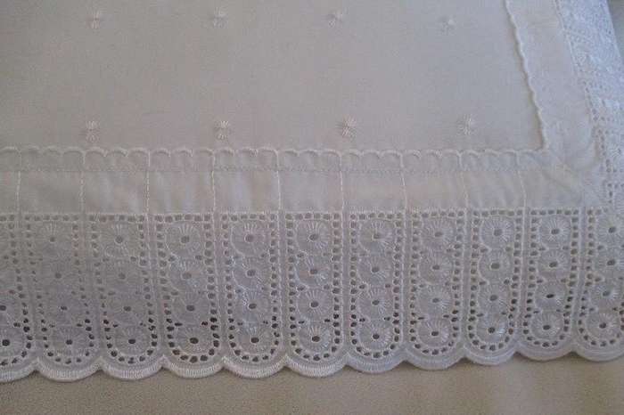 Pretty cushion with wide embroidered lace border