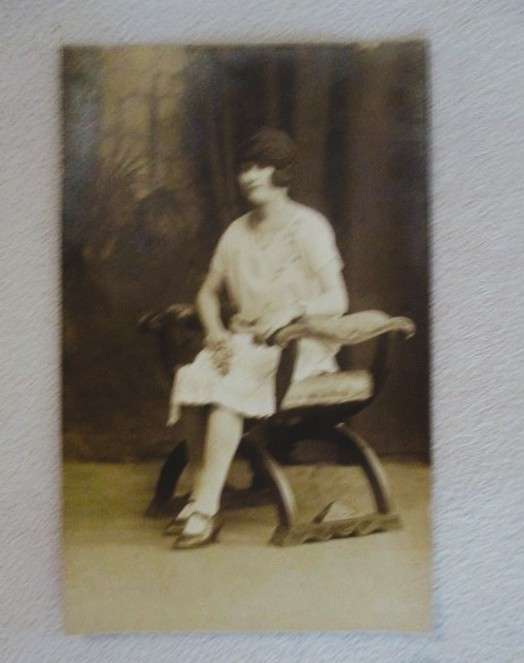 Antique early 1900's postcard - lady sitting in a chair