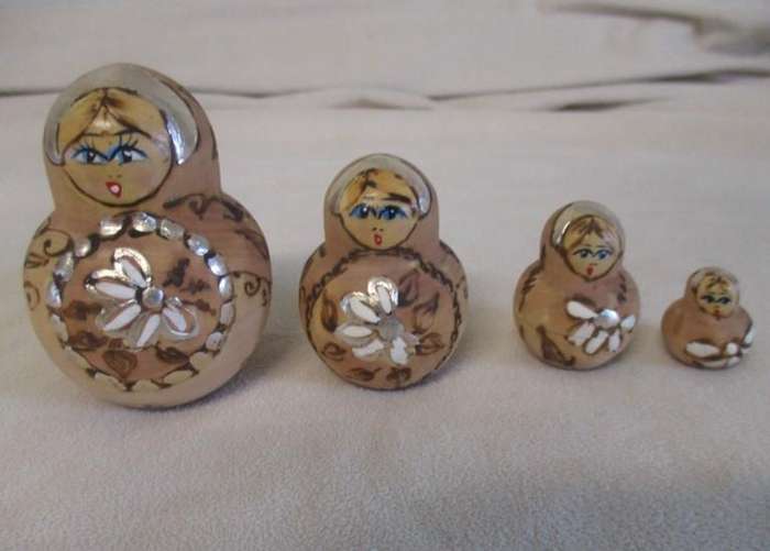 Four piece set of vintage Russian wooden hand painted Matryoshka nesting dolls