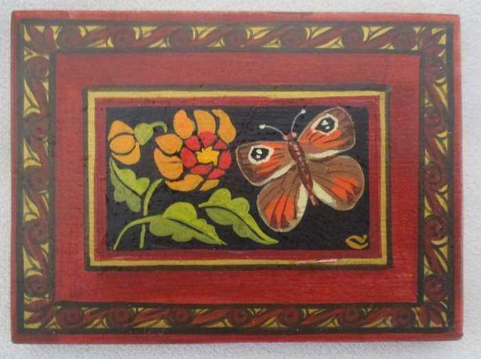 Five hand painted wooden wall plaques with various butterflies