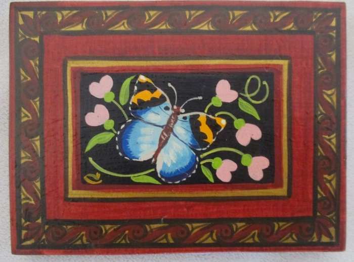 Five hand painted wooden wall plaques with various butterflies