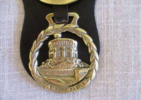 Two rather large horse brasses on leather strap