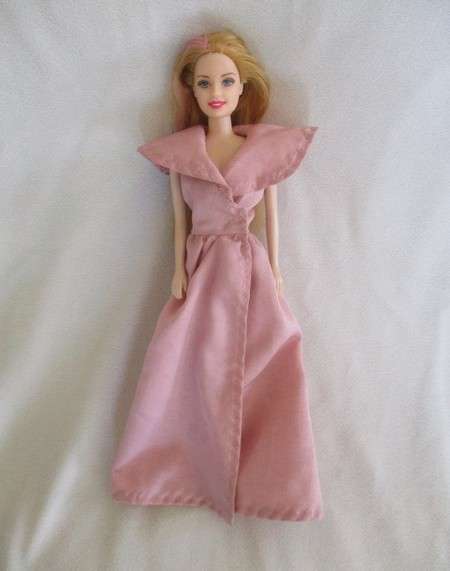 A pretty vintage doll with pink highlights and tinsel in her hair