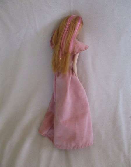 A pretty vintage doll with pink highlights and tinsel in her hair