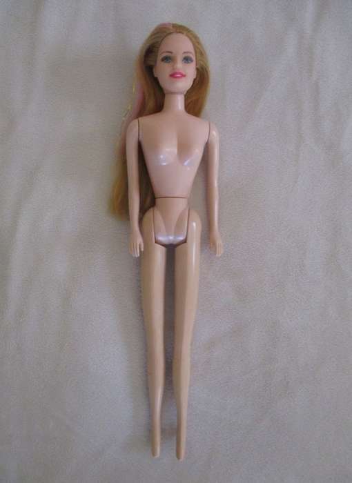 A pretty vintage doll with pink highlights and tinsel in her hair