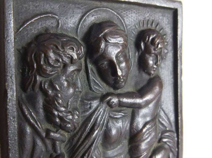An old bronze plaque deskpiece depicting The Holy Family on an either marble or alabaster base