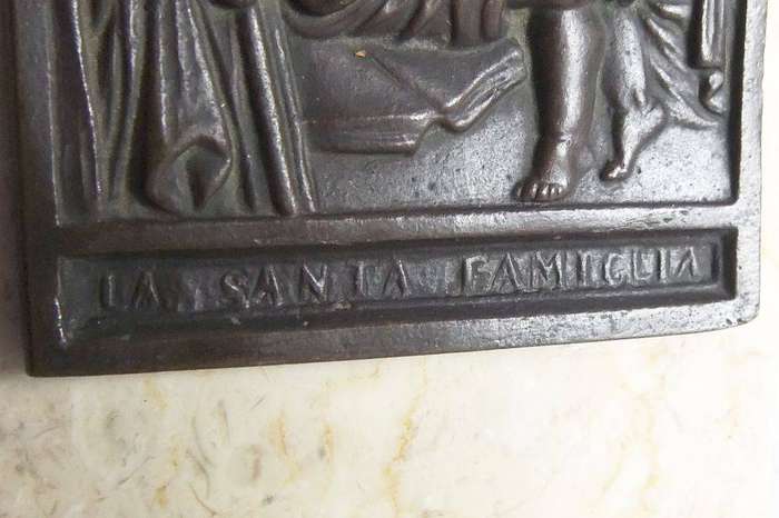An old bronze plaque deskpiece depicting The Holy Family on an either marble or alabaster base