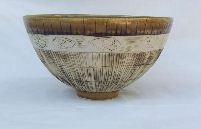 A large vintage hand made pottery fruit bowl with makers mark to base