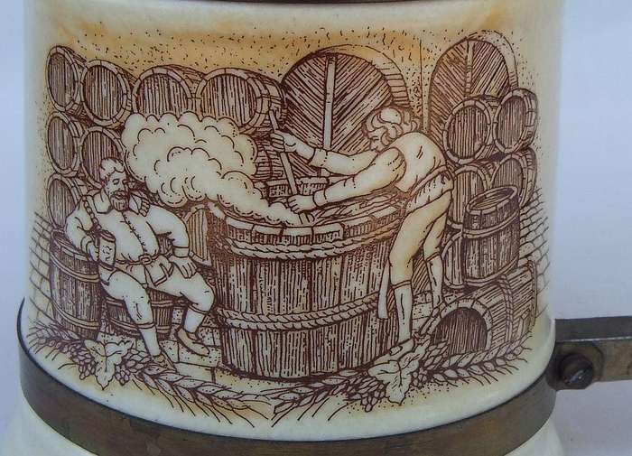A vintage bar jug with wine / beer brewers theme and metal handle