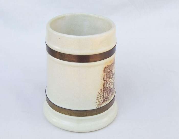 A vintage bar jug with wine / beer brewers theme and metal handle