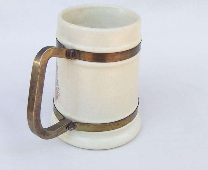 A vintage bar jug with wine / beer brewers theme and metal handle