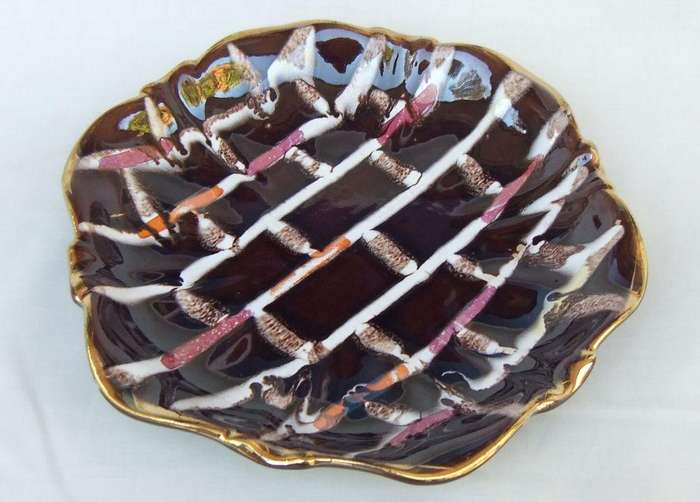 A vintage mid-century hand painted and numbered German pottery snack dish