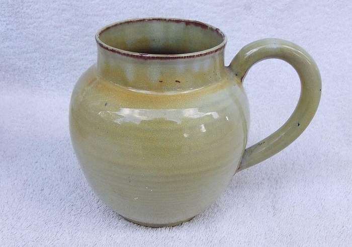 A vintage pottery ewer in the style of Globe or Linn ware pottery