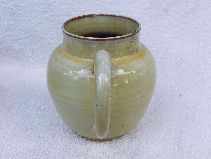 A vintage pottery ewer in the style of Globe or Linn ware pottery