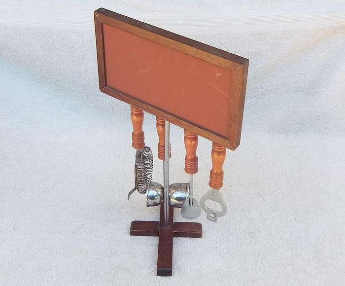 A vintage bar tool stand with mirror and accessories