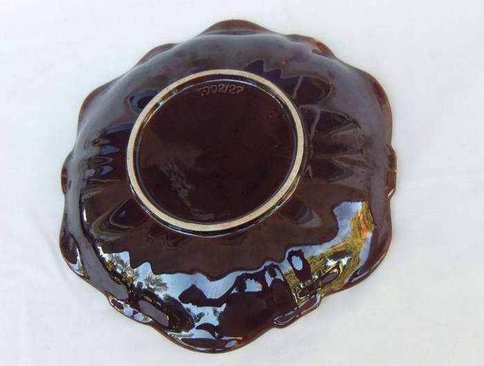 A vintage mid-century hand painted and numbered German pottery snack dish