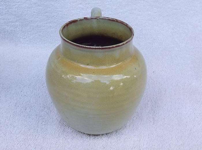 A vintage pottery ewer in the style of Globe or Linn ware pottery