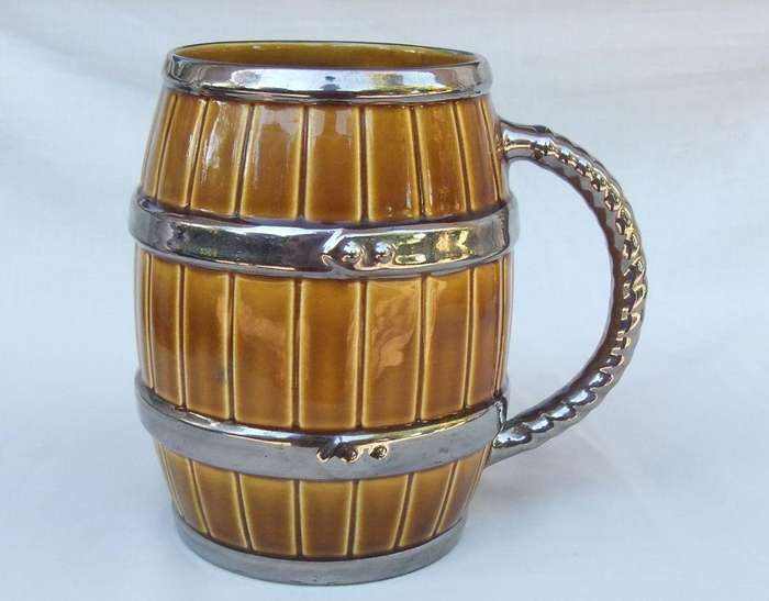 An oversized bar jug modelled as a barrel made by Wade England