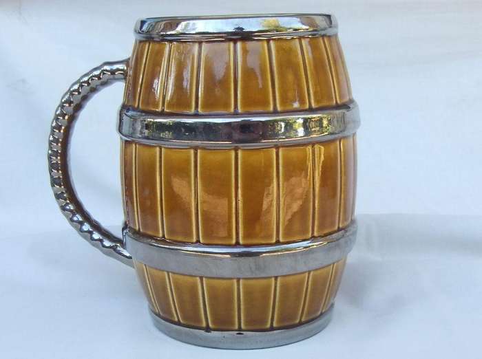 An oversized bar jug modelled as a barrel made by Wade England