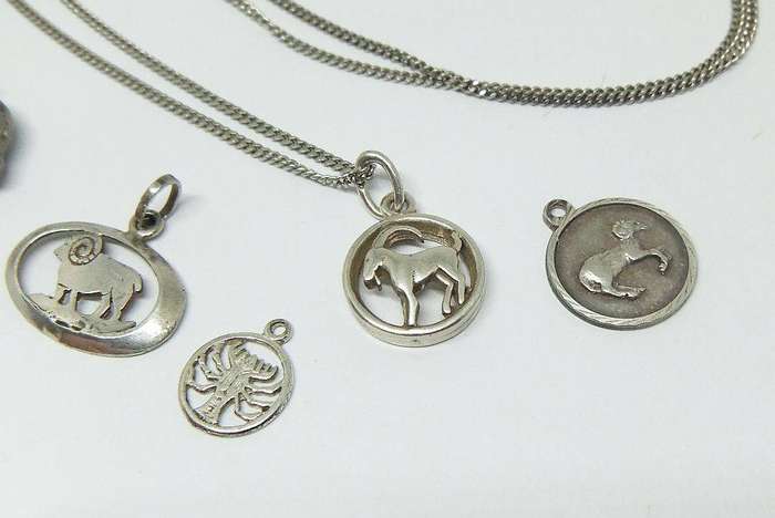 A long sterling silver necklace with a variety of 835 silver and sterling silver pendants or charms