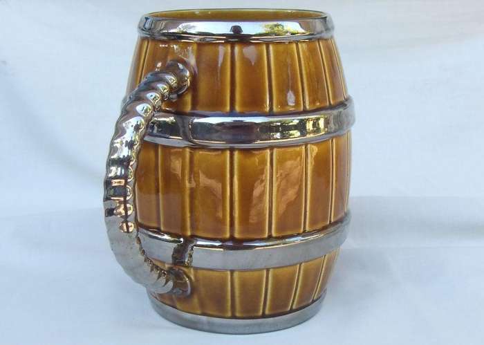 An oversized bar jug modelled as a barrel made by Wade England