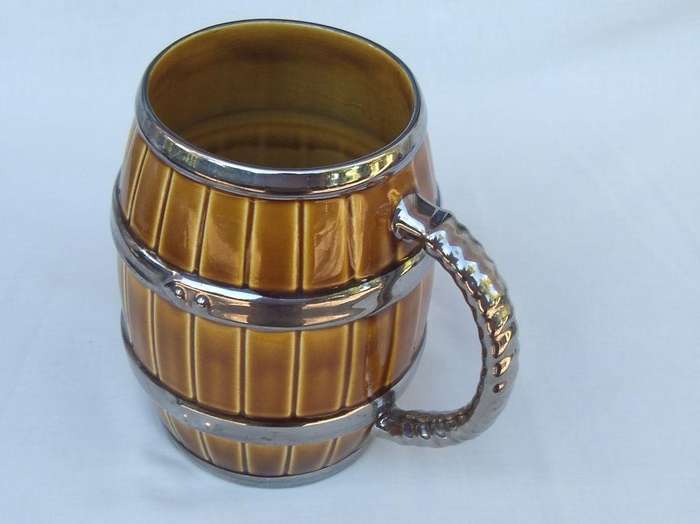 An oversized bar jug modelled as a barrel made by Wade England