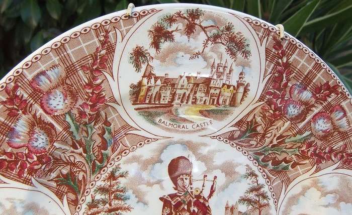 A vintage porcelain display plate by Weatherby depicting scenes of Scotland