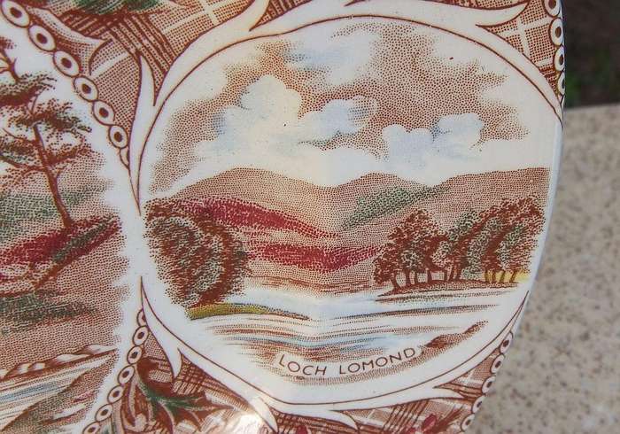 A vintage porcelain display plate by Weatherby depicting scenes of Scotland