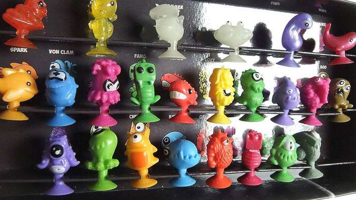 A collection of Stikeez figures with submarine holder which doubles as a board game