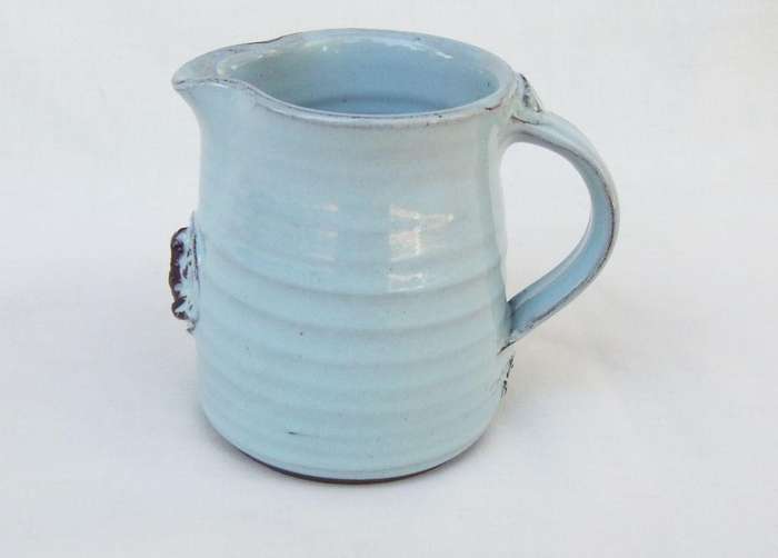 A signed South African pottery mug with frog motif