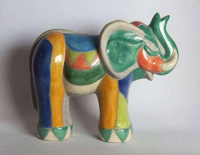 A large signed hand painted Raku pottery elephant figure in prestine condition