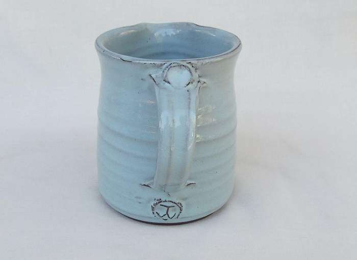A signed South African pottery mug with frog motif