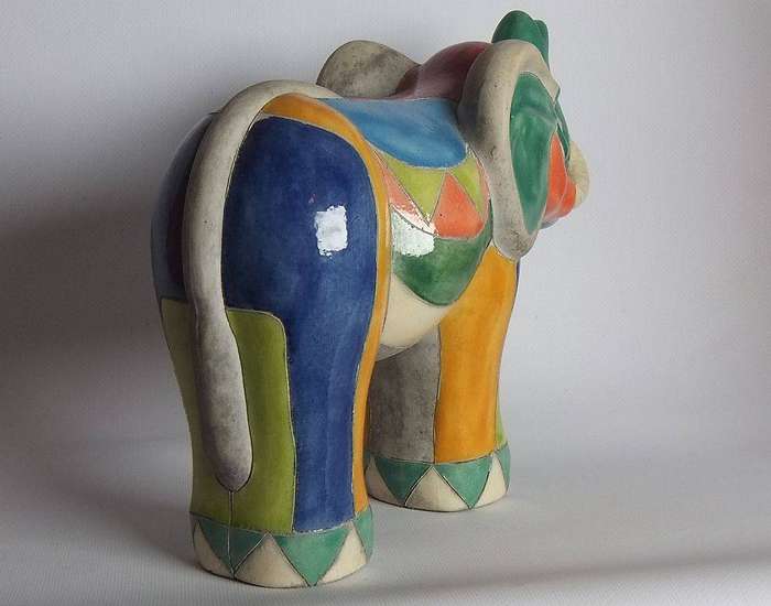 A large signed hand painted Raku pottery elephant figure in prestine condition