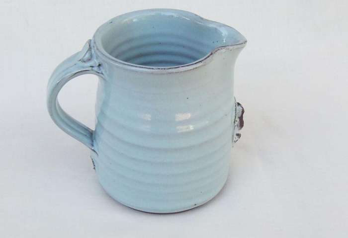 A signed South African pottery mug with frog motif