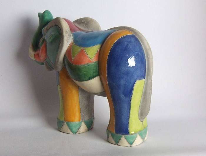 A large signed hand painted Raku pottery elephant figure in prestine condition