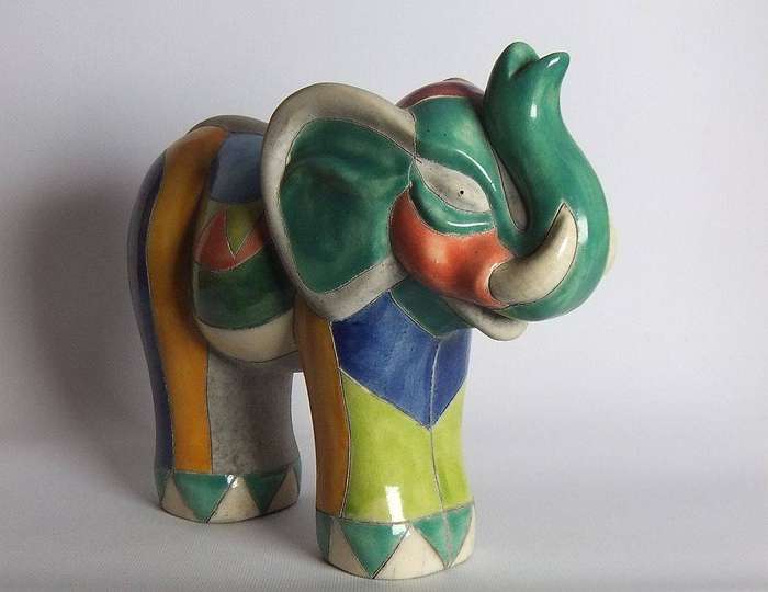 A large signed hand painted Raku pottery elephant figure in prestine condition