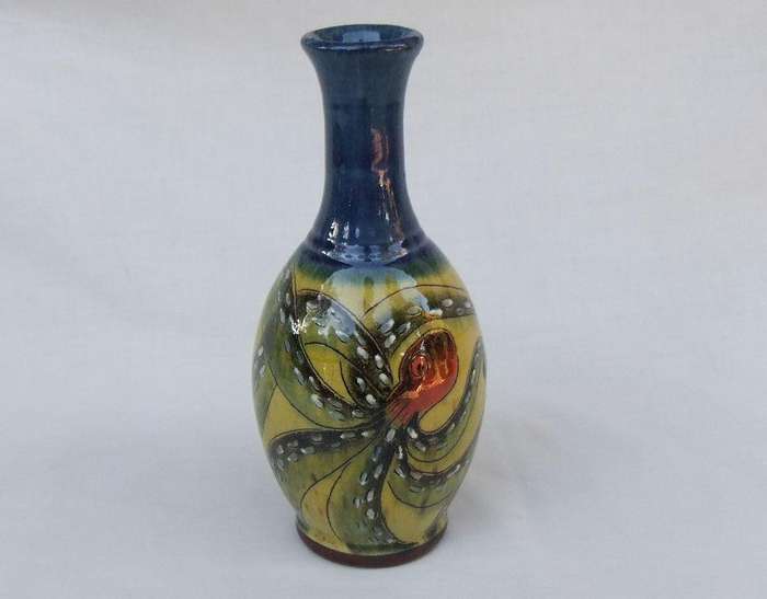 A signed vintage handmade pottery vase with octopus motif