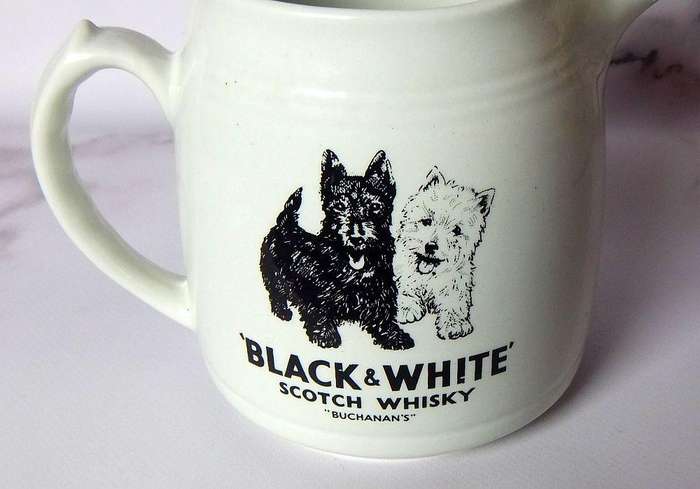 A vintage pub water jug advertising Black & White whisky