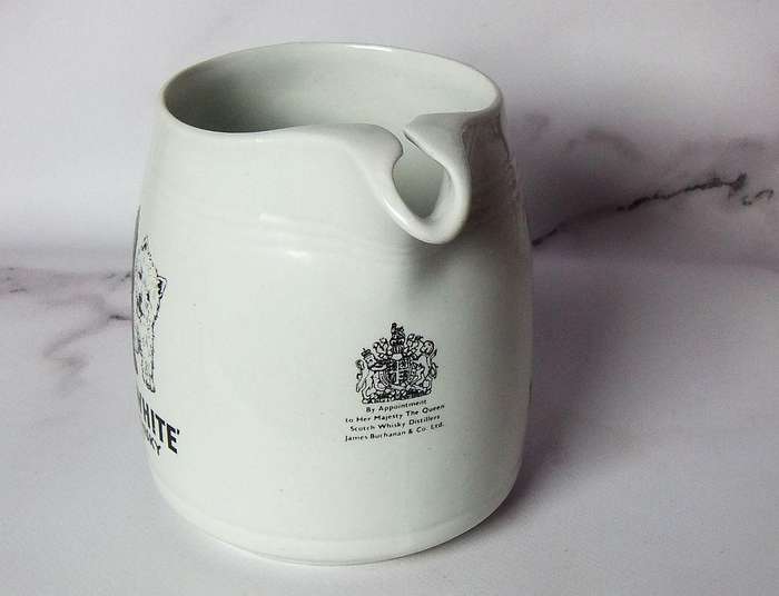 A vintage pub water jug advertising Black & White whisky