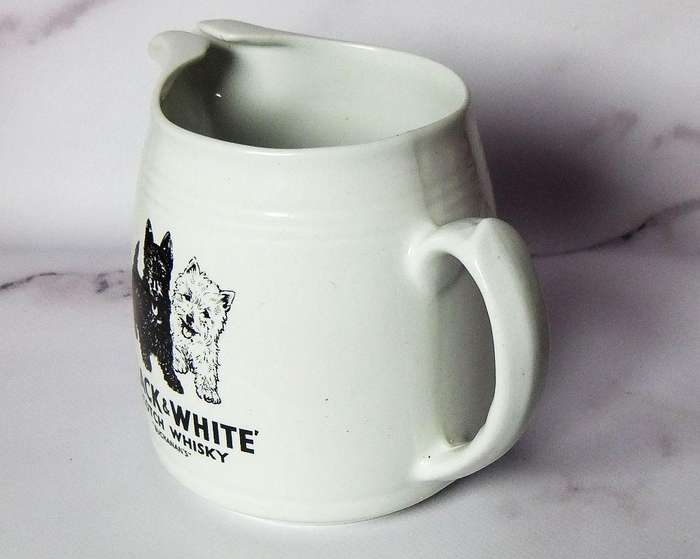 A vintage pub water jug advertising Black & White whisky