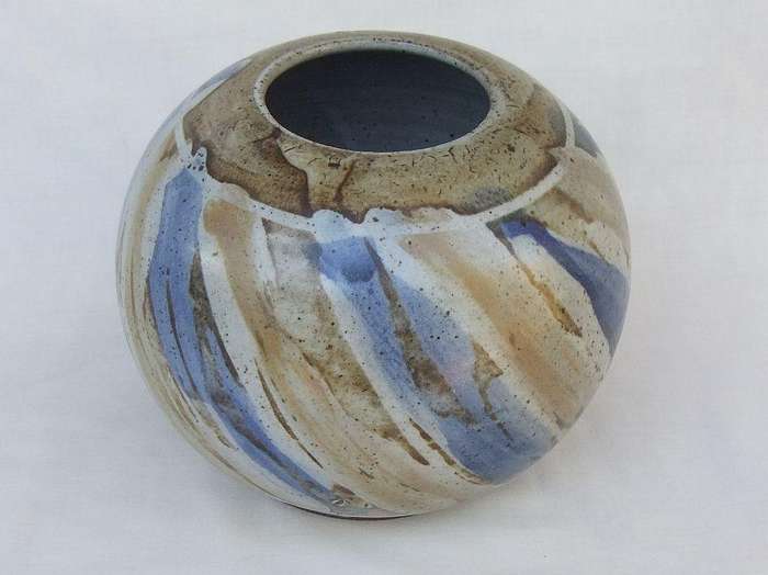 A heavy quality hand made pottery vase with makers signature to base
