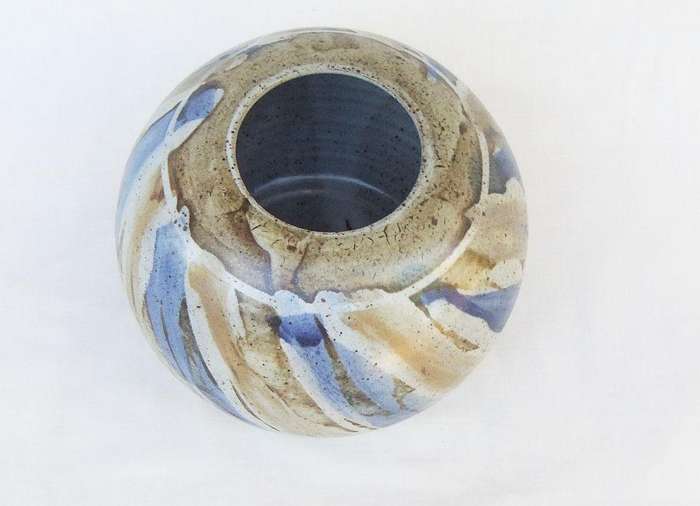 A heavy quality hand made pottery vase with makers signature to base