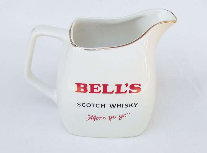 A vintage Bells whisky advertising bar water jug made by Wade England