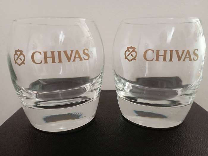 A pair of Chivas gold logo whisky glasses with heavy bottoms in excellent condition as per scan