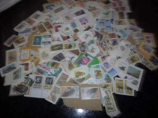 500 X USED STAMPS ON PAPER SEE PICS