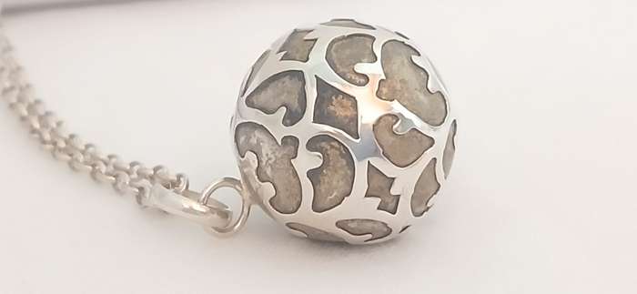 Sterling silver pendant with brass chime on chain