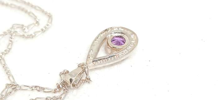 Sterling silver pendant with purple stone