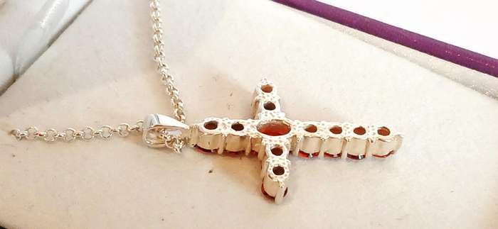 Sterling silver cross pendant with orange stones on chain